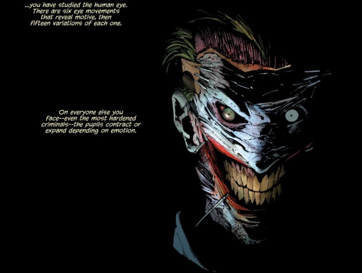A panel from Batman #15 (2011) with text and the Joker wearing his skin mask