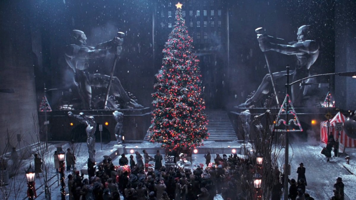 A giant Christmas tree lit up between two huge statues in Batman Returns