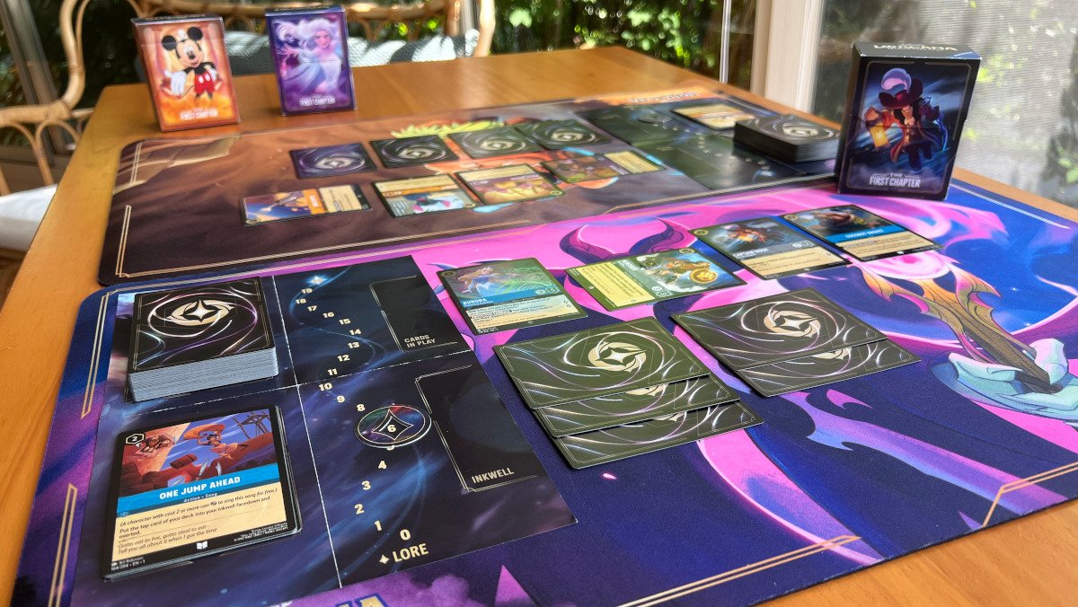 Two Disney Lorcana playmats with the cards set up