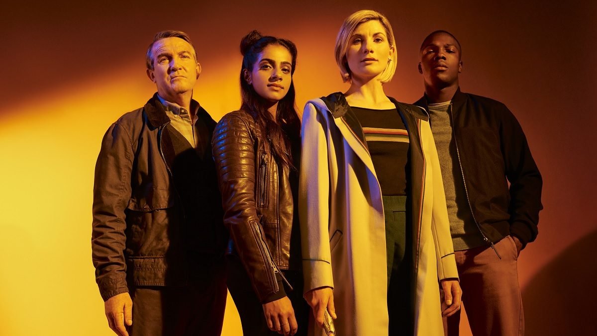 photo of thirteen doctor with her three companions standing in a yellow light for Doctor Who season 11 promo