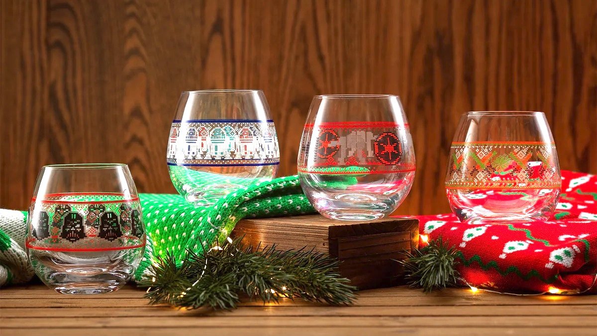 Four ugly Christmas sweater themed Star Wars glasses on a holiday themed display from Joy Jolt
