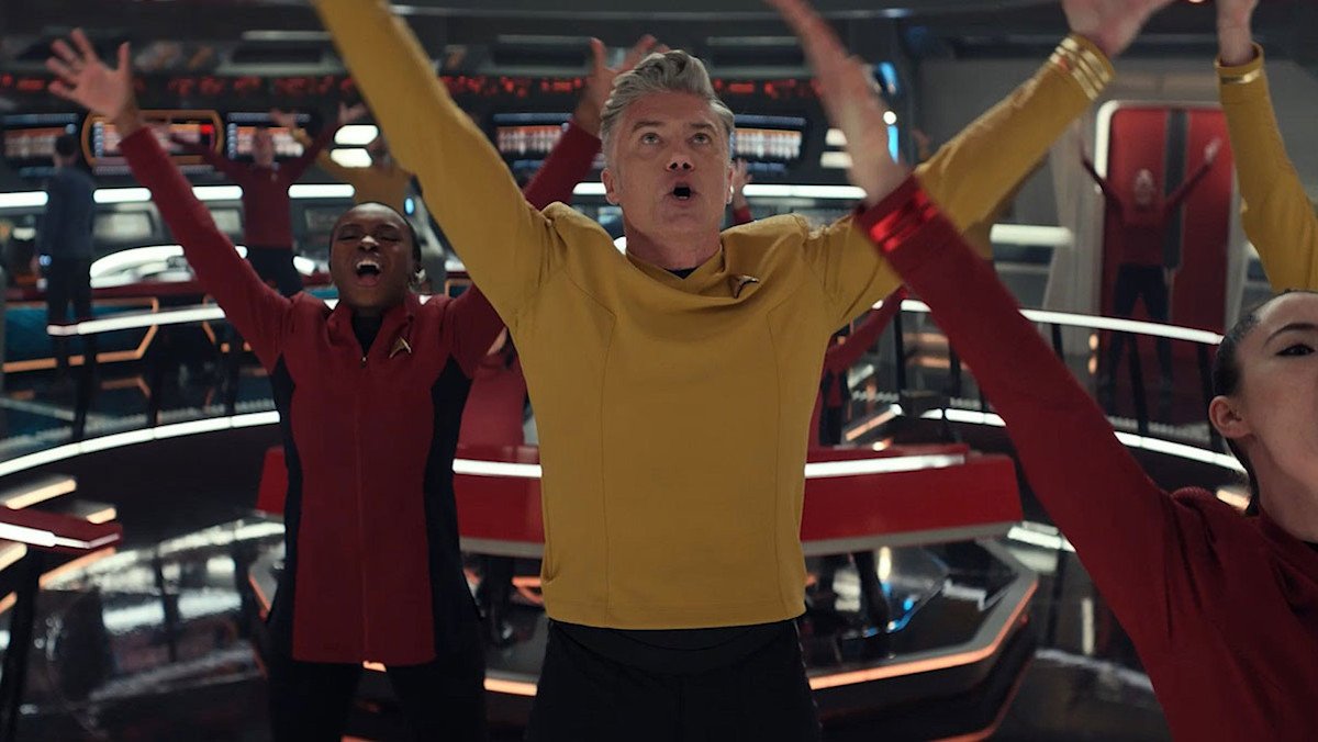 Captain Pike leads the crew of the Enterprise in an ensemble dance for the Star Trek: Strange New Worlds musical episode