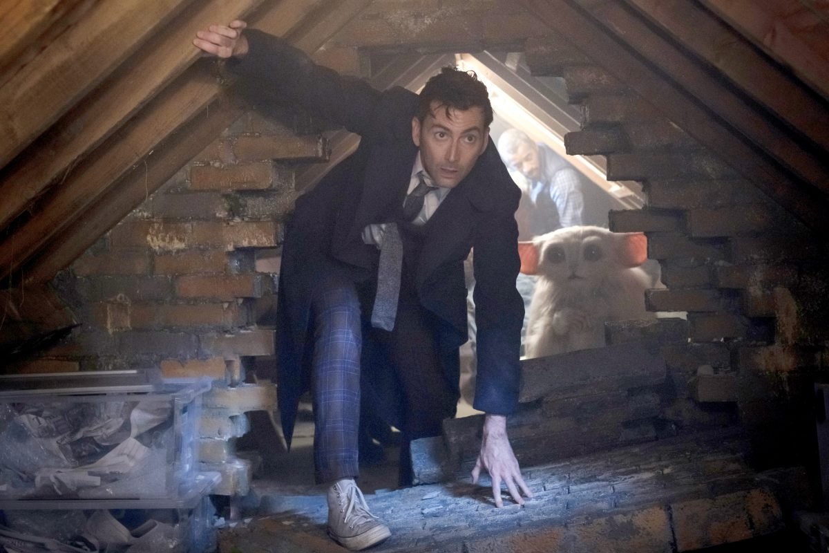 the Fourteenth doctor and beep the meep look out of a hole in an attic